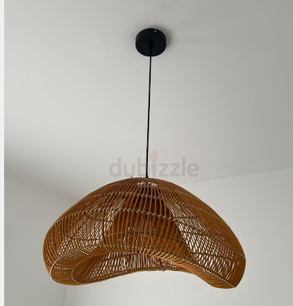 Woven rattan pendant lamp with black cord and simple black canopy