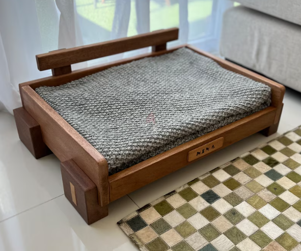 Contemporary hard wood pet bed. Brand new.