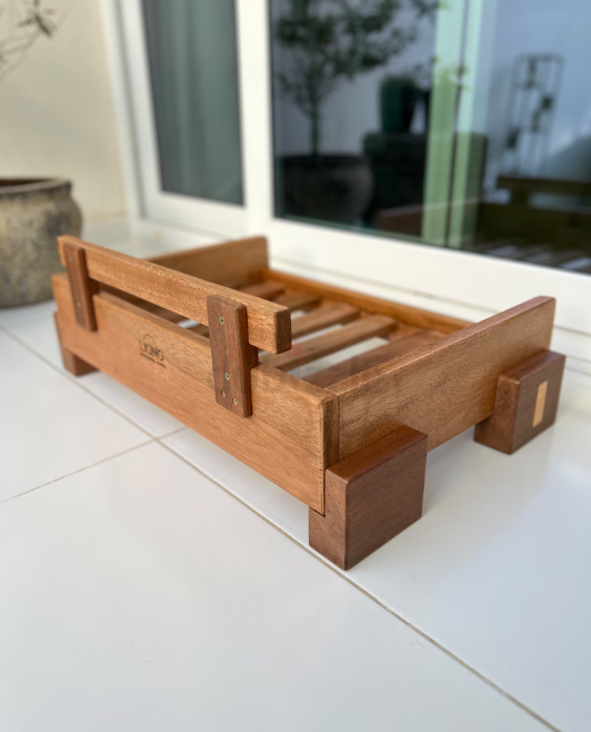 Contemporary hard wood pet bed. Brand new.