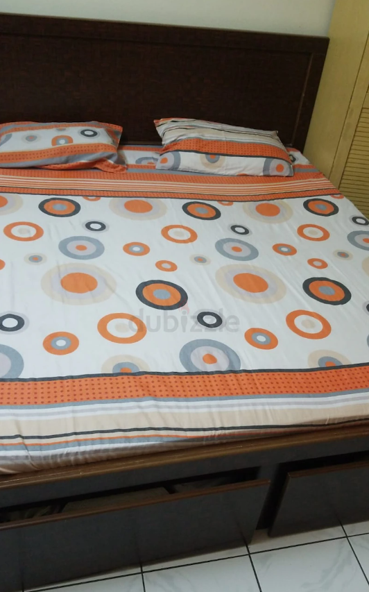 Dark brown double bed with storage