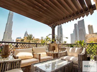 Aesthetics of traditional Arabian village w/ Burj Khalifa views